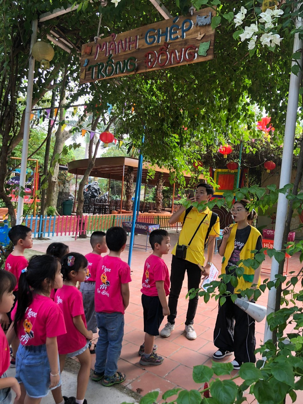 A group of children standing under a sign

Description automatically generated