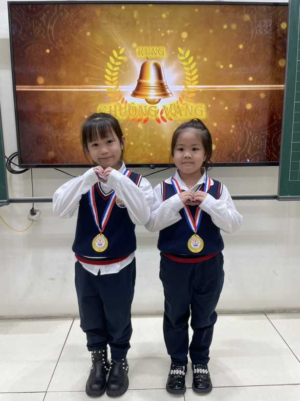 Two girls in uniform with medals

Description automatically generated