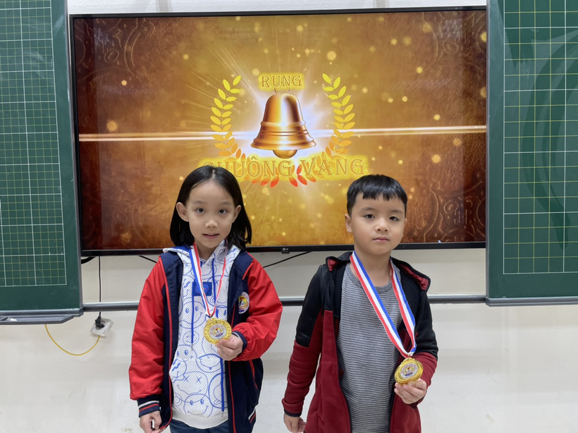 A child and child holding medals

Description automatically generated
