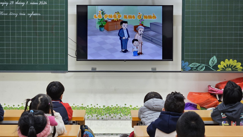 A group of kids sitting in a classroom watching a cartoonDescription automatically generated