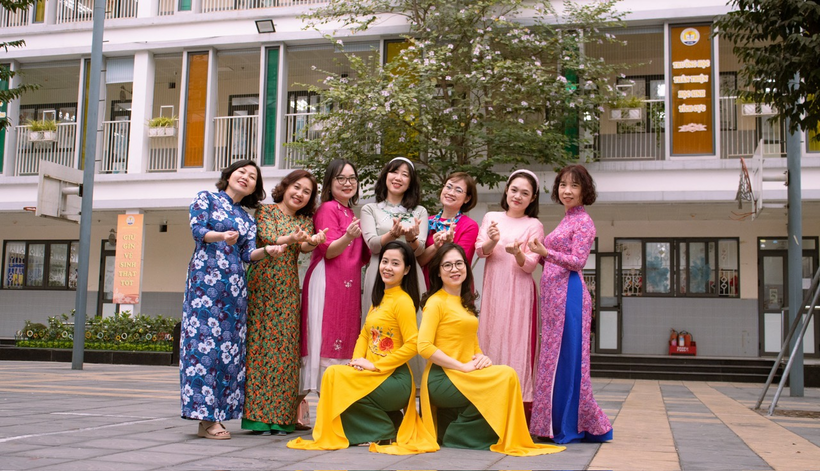 A group of women in colorful dresses posing for a photo

Description automatically generated