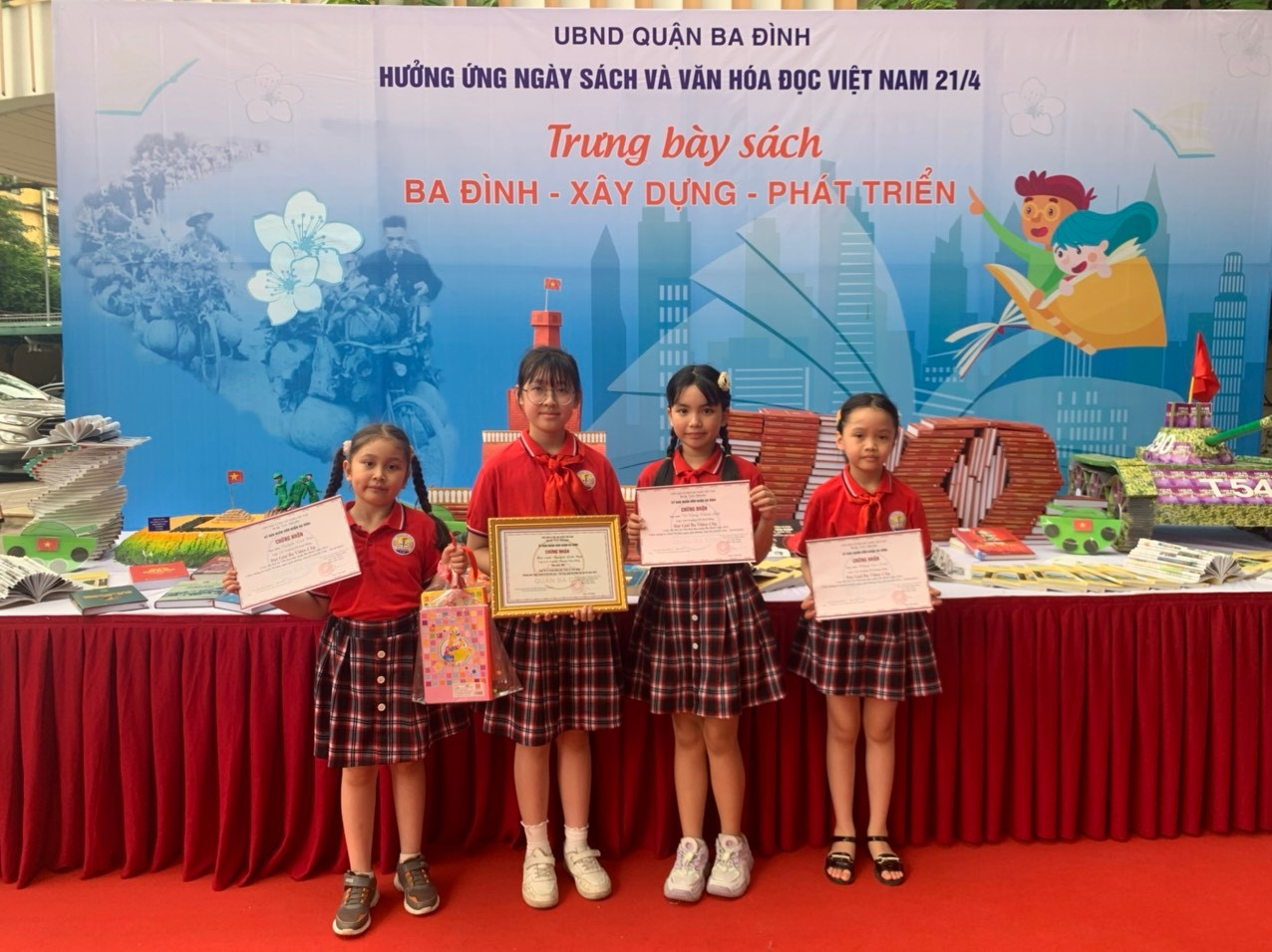 A group of girls holding certificatesDescription automatically generated