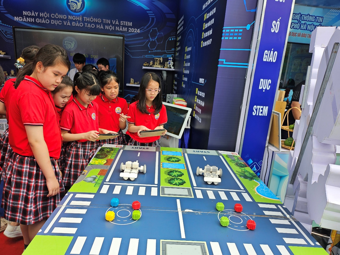 A group of children in red shirts playing a gameDescription automatically generated